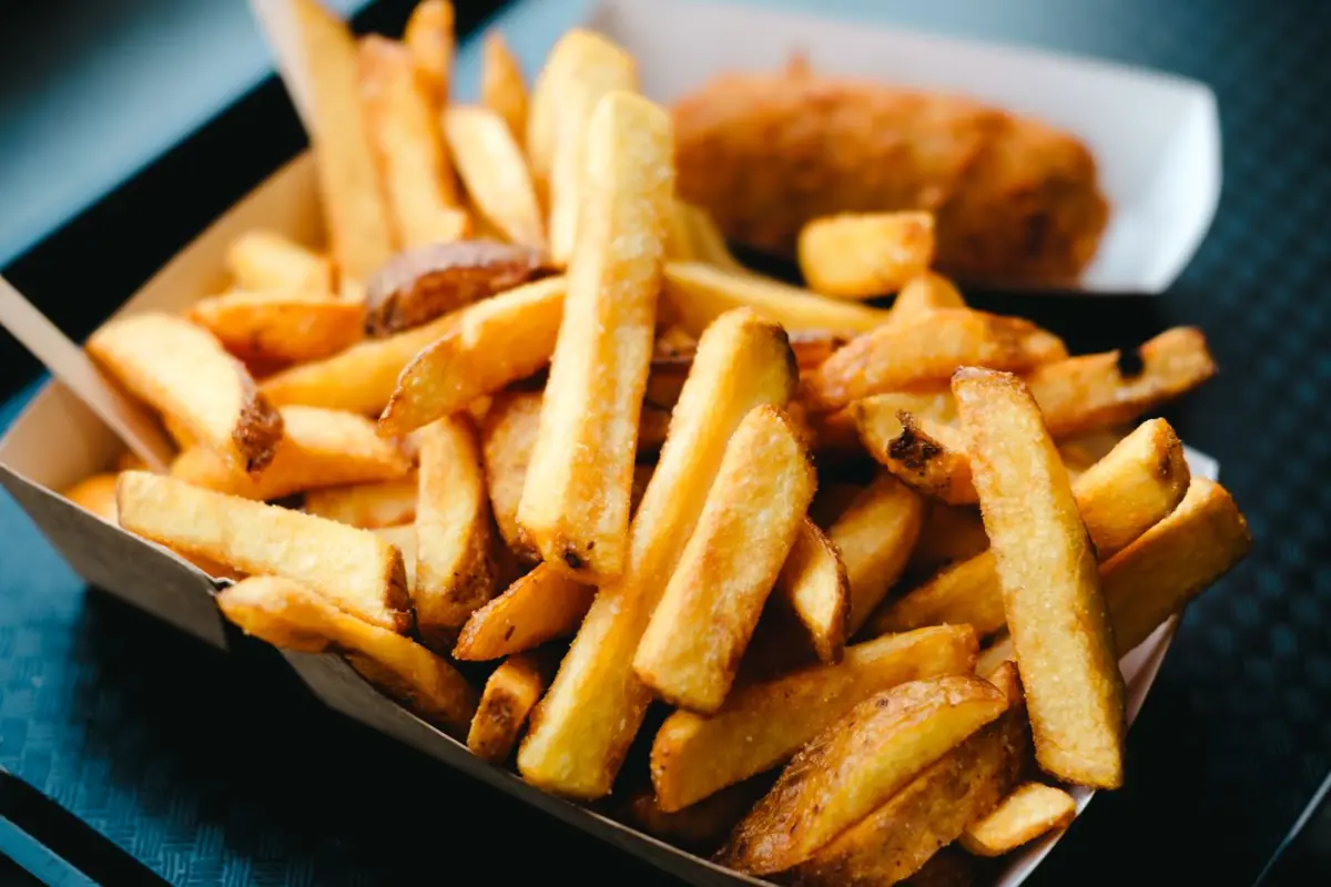 Freshly fried Belgian fries in a takeaway tray